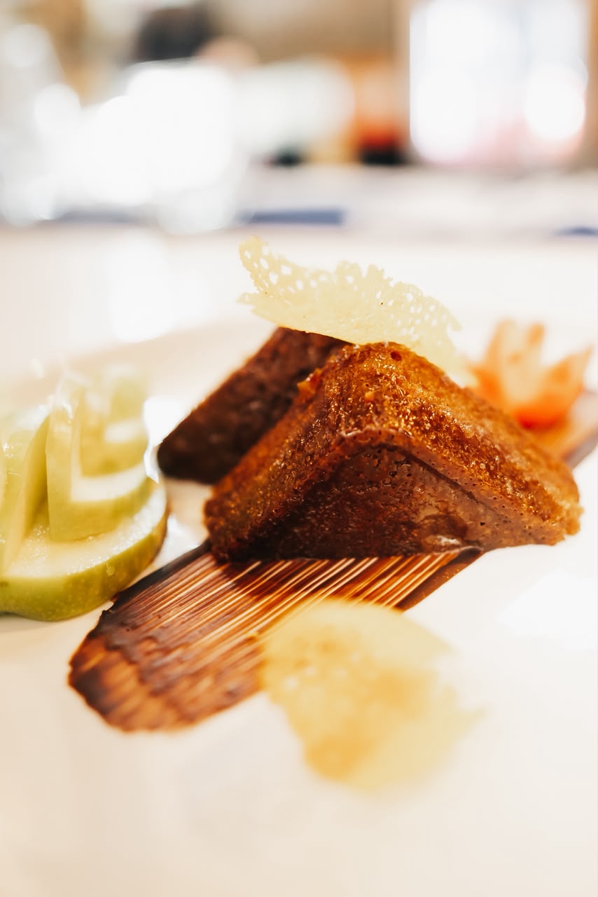 Seared grill plated with cucumber fan and parmesan crisp